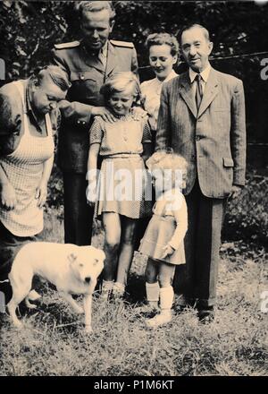 THE CZECHOSLOVAK SOCIALIST REPUBLIC - CIRCA 1960s: Retro photo shows family and dog outside. Black & white vintage photography Stock Photo