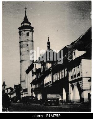 DOMAZLICE, THE CZECHOSLOVAK SOCIALIST REPUBLIC - CIRCA 1960s: Retro photo shows landmark of Domazlice - the tower of the archdean´s church in the square. It is 56 metres high and its deviation from the axis is 60 cm. Black & white vintage photography. Stock Photo