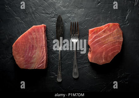 Raw Tuna Steak on Dark Stone Background Stock Photo