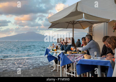 Porta a Marina restaurant in the Marina Grande with Mount Vesuvius across the Bay of Naples at sunset, Sorrento, The Amalfi Coast, Campania, Italy Stock Photo