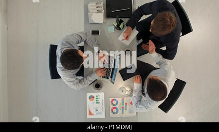 Top view of Business partners discussing documents and ideas at meeting Stock Photo