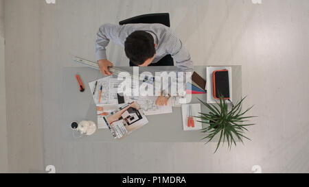 Architect is working on plan of building with a ruler. Top view Stock Photo