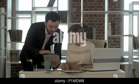 Concentrated business people using digital tablet in meeting at the office Stock Photo