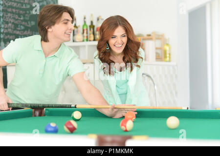 young couple playing billiard Stock Photo
