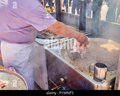 Cook frying Entresijos (Lamb Mesentery) in a stall of a Street Food fair. Stock Photo