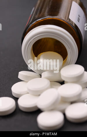 Close-up of bottle with pills and capsules falling out Stock Photo ...