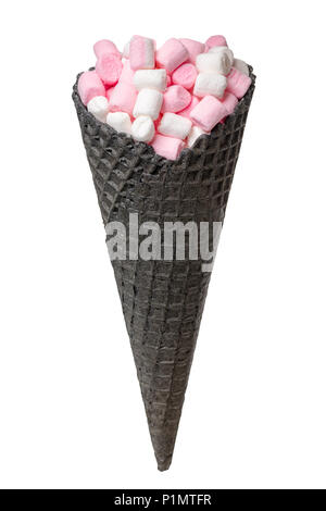 black waffle cone with white and pink marshmallows isolated on white background, concept of sweet dessert Stock Photo