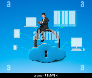 Using tablet and sitting on cloud shape locker with devices drawing Stock Photo