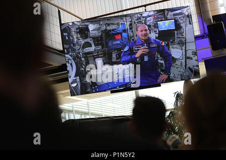 12 June 2018, Germany, Cologne: German astronaut Alexander Gerst can be seen on a monitor at the ESA, as he answers journalists' questions from the International Space Station. Photo: Oliver Berg/dpa Stock Photo