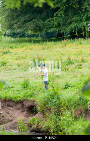 Glasgow, Scotland, UK. 12th June, 2018. UK Weather: A young man, Jamie McKeown, fly fishing from the banks of the White Cart Water on a sunny afternoon in Pollok Country Park. Credit: Skully/Alamy Live News Stock Photo