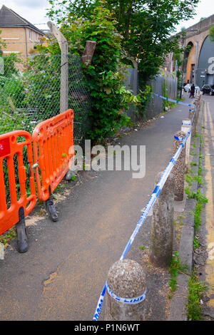 South Harrow, London, England. 12th June 2018. Police search for clues and protect the scene of the latest violent incident in Harrow, contributing to the continuous violent crime rates in London. The location is very close to recent stabbing of a 17 year old and is part of the same investigation.  The Police would only say that someone had been very badly injured. They were undertaking a finger tip search of the crime scene on Roxeth Green Avenue, South Harrow. Credit © Tim Ring/Alamy Live News Stock Photo