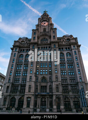 Liverpool Waterfront, Liverpool, England, United Kingdom, 12th June 2018. UK Weather: sunset over the dock area in Liverpool. The ornate historic Art Deco Royal Liver building makes a striking contrast to the low light at sunset, with the clock tower lit up at night Stock Photo