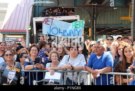 New York, USA. 12th June 2018. 12 June 2018, New York, USA: Fans wait for US Hollywood star John Travolta and his wife, actress Kelly Preston, in front of the food stall 'Lenny's Pizza' on 86th Street in Bensonhurst. Travolta bought two slices of Margehrita in his role of Tony Manero in the classic disco movie 'Saturday Night Fever' some 40 years ago. Photo: Christina Horsten/dpa Credit: dpa picture alliance/Alamy Live News Stock Photo