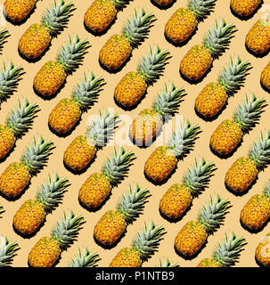 Pineapple pattern of whole pineapples. Flat lay diagonal with drop shadow on yellow-cream background. Stock Photo