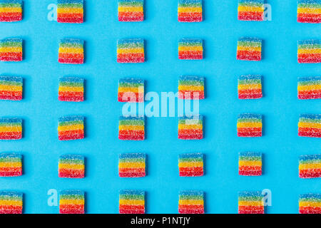 Colorful candies pattern on a blue background. Top view. Stock Photo