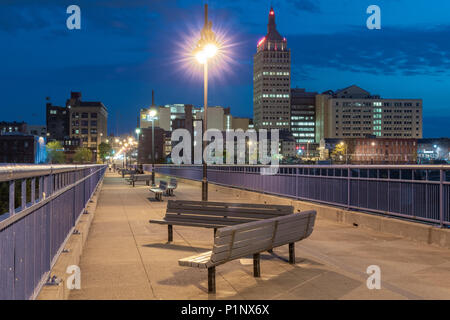 ROCHESTER, NY - MAY 14, 2018: Skyline of Rochester, New York along the Pont De Rennes Pedestrian Bridge which is part of the Genesee Riverway Trail at Stock Photo