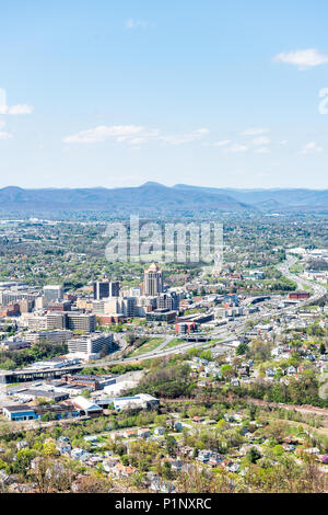 Roanoke, USA - April 18, 2018: Aerial Cityscape Skyline view of city in Virginia during spring with office buildings headquarters, mountains, highway  Stock Photo