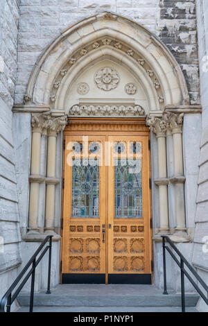 Stone Gothic Arch Church Entrance with Stained Glass Door Stock Photo