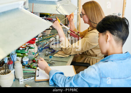 Two Female Artists Collaborating in Glassworking Shop Stock Photo
