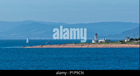 CHANONRY POINT MORAY FIRTH SCOTLAND WITH LIGHTHOUSE PEOPLE ON THE BEACH AND KESSOCK BRIDGE INVERNESS IN DISTANCE Stock Photo