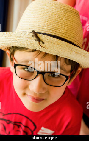 Boy with baby lizard on his tropical straw hat; Varadero, Cuba Stock Photo