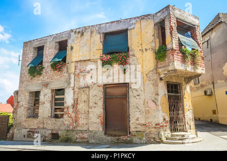 VUKOVAR, CROATIA - MAY 14, 2018 : Uninhabited houses with damages from the Yugoslav Wars in the 90s in Vukovar, Slavonia, Croatia. Stock Photo