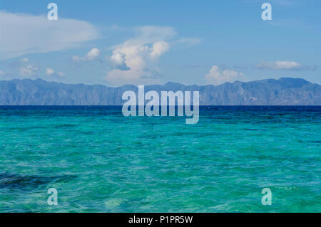 Clear, turquoise waters and the rugged, rocky coastline of the Philippines; Coron, Palawan, Philippines Stock Photo