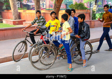 Local boys riding bicycles in Taj Ganj neighborhood of Agra, Uttar Pradesh, India. Agra is one of the most populous cities in Uttar Pradesh Stock Photo