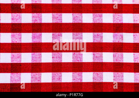 Red and white checked or striped gingham tablecloth, for use as a background or wallpaper Stock Photo