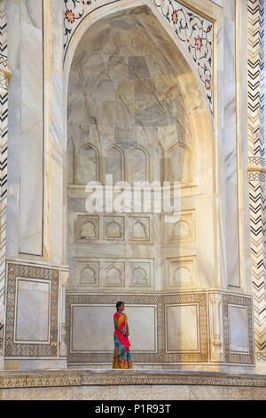 Woman standing outside Taj Mahal in Agra, Uttar Pradesh, India. Taj Mahal was designated as a UNESCO World Heritage Site in 1983. Stock Photo