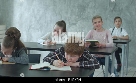 Group of elementary school kids running after lesson Stock Photo