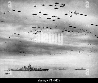 Surrender of Japan, 2 September 1945: U.S. Navy carrier planes fly in formation over the U.S. and British fleets in Tokyo Bay during surrender ceremonies. The battleship USS Missouri (BB-63), where the ceremonies took place, is at left. The light cruiser USS Detroit (CL-8) is in the right distance. Aircraft include Grumman TBM Avenger, Grumman F6F Hellcat, Curtiss SB2C Helldiver and Vought F4U Corsair types. September 2, 1945 Stock Photo