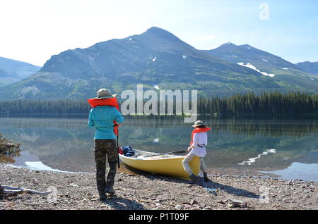 Two girls boating on Lake Waterton in Alberta, Canada. Stock Photo