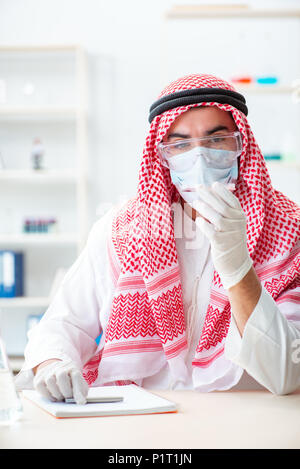 Arab doctor chemist studying new virus in lab Stock Photo