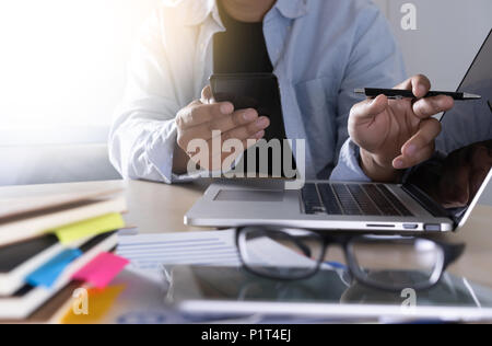 businessman using phone smart phone and notebook computer Stock Photo