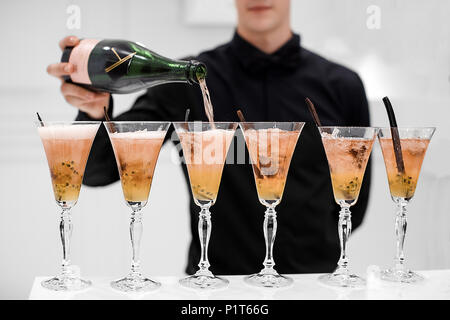 Waiter pouring champagne in glasses Stock Photo