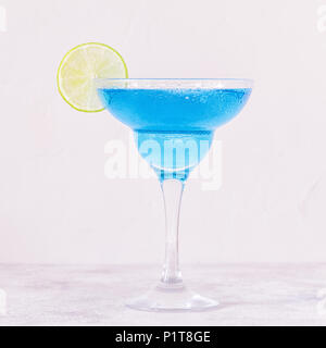 Blue Curacao cocktail decorated with fruit, selective focus. Stock Photo
