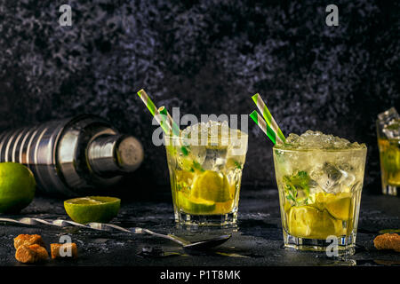 Fresh lime cocktail with ice on dark background. Stock Photo
