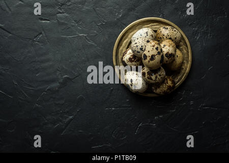 Quail Eggs on Dark Stone Background Stock Photo
