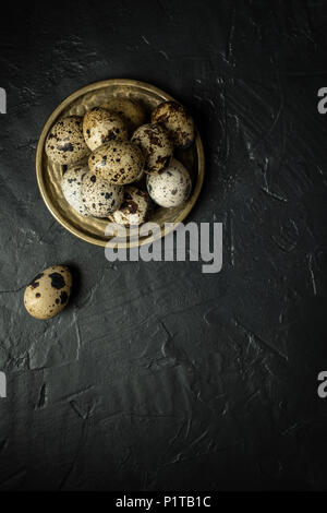 Quail Eggs on Dark Stone Background Stock Photo
