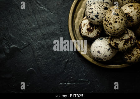 Quail Eggs on Dark Stone Background Stock Photo