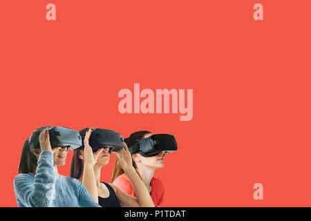 Young beautiful girls in virtual reality glasses. The concept of modern technologies and technologies of the future. VR glasses Stock Photo