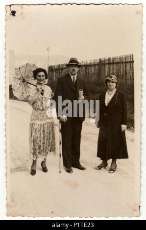 https://l450v.alamy.com/450v/p1te23/trencianske-teplice-the-czechoslovak-republic-circa-1930s-vintage-photo-shows-women-and-man-at-the-spa-resort-one-of-the-woman-holds-a-parasol-original-retro-black-white-photography-p1te23.jpg