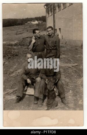 THE CZECHOSLOVAK REPUBLIC - CIRCA 1940s: Vintage photo shows a group of workers (labours) poses outdoor. Retro black & white photography. Stock Photo