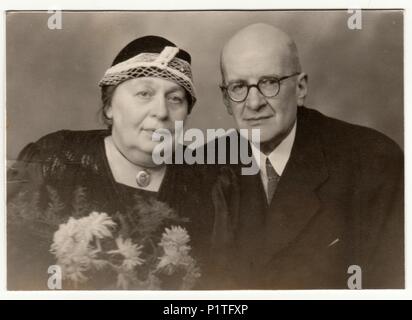 KLATOVY, THE CZECHOSLOVAK SOCIALIST REPUBLIC - NOVEMBER 10, 1949: Vintage photo shows a married couple - silver wedding (anniversary). Retro black & white studio photography. Stock Photo