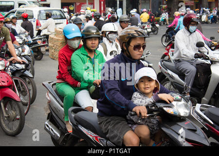 Saigon, Vietnam - January 2014: Scooter traffic on crowded streets with many motorbikes in Saigon a.k.a. Ho Chi Minh City, Vietnam Stock Photo