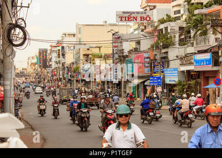 Saigon, Vietnam - January 2014: Scooter traffic on crowded streets with many motorbikes in Saigon a.k.a. Ho Chi Minh City, Vietnam Stock Photo