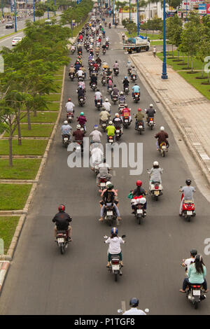 Saigon, Vietnam - January 2014: Scooter traffic on crowded streets with many motorbikes in Saigon a.k.a. Ho Chi Minh City, Vietnam Stock Photo