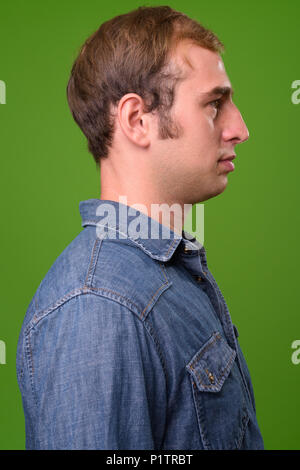 Young man against green background Stock Photo