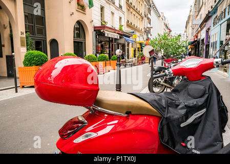 A bright red scooter on a Paris street Stock Photo